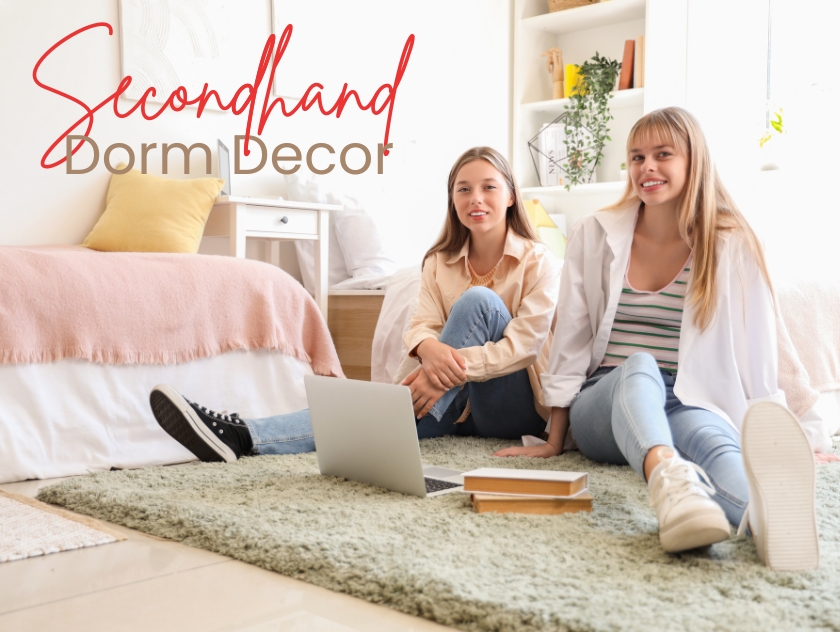 Two college students sit on the floor of their dorm room.