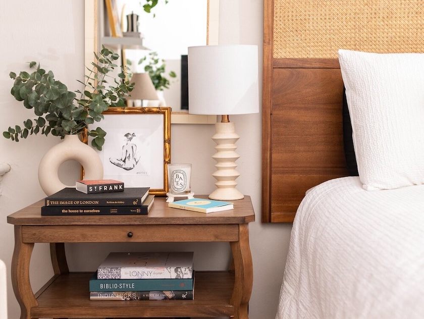 Stylish mini lamp from a thrift sale on a bedside table, enhancing this small space. 