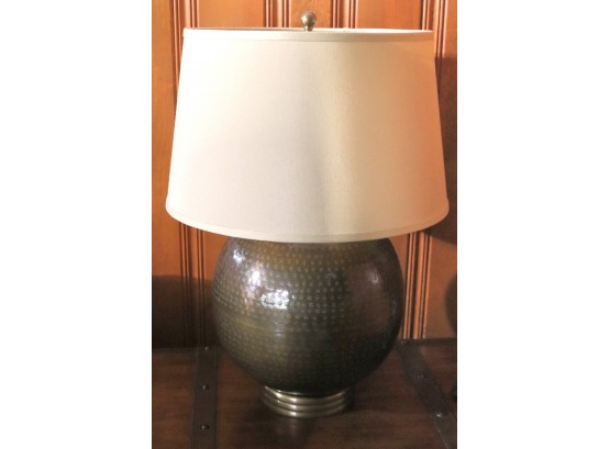 Hand Hammered Round Metal Table Lamp With Antique Brass Patina And Tan Shade.