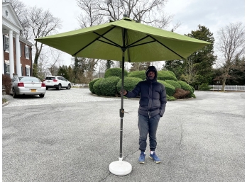 Green Sunbrella Outdoor Umbrella With A Syroco Resin Umbrella Stand